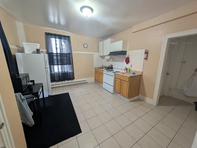 a kitchen with stainless steel appliances granite countertop a refrigerator stove and sink