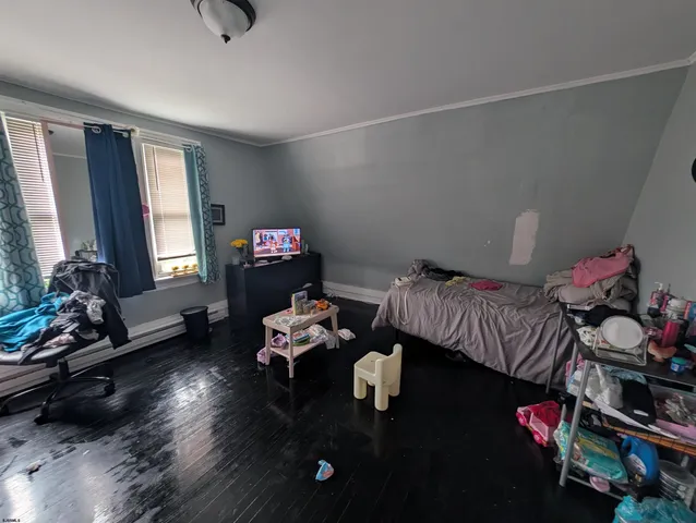 a bedroom with furniture and a wooden floor