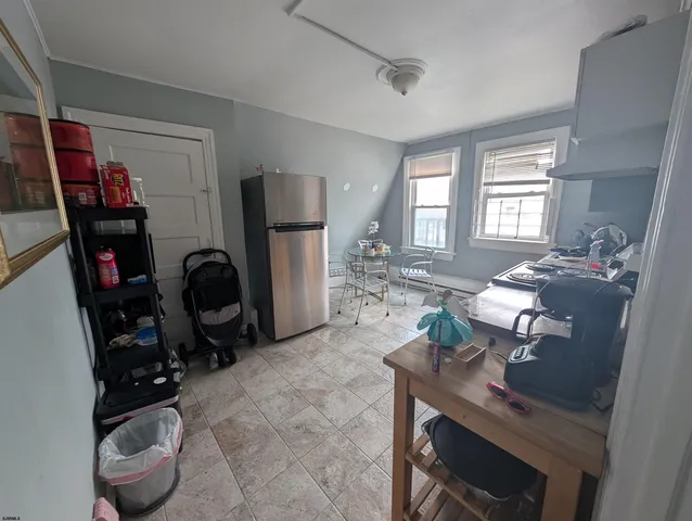 a living room with furniture a window and gym equipment