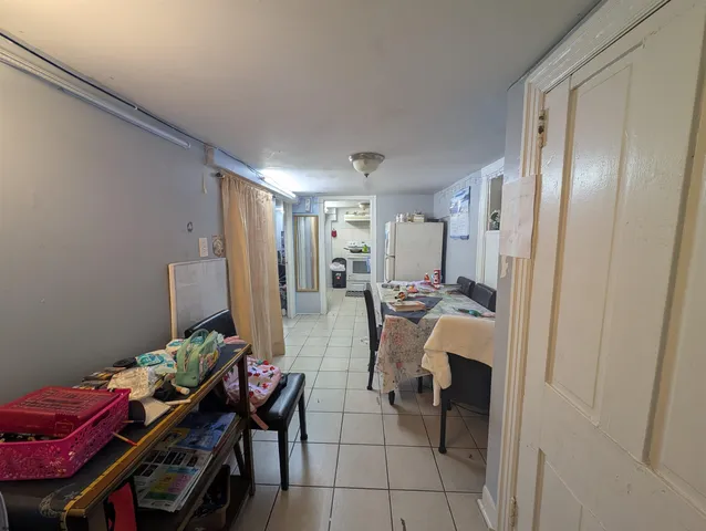 a view of a dining room with furniture and a chandelier