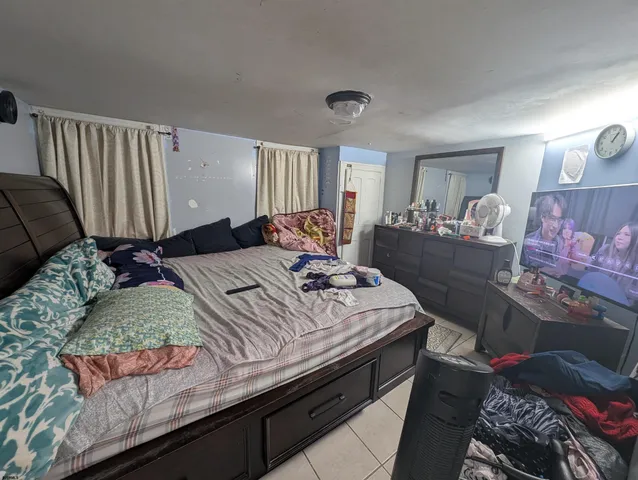 a bedroom with a bed and window