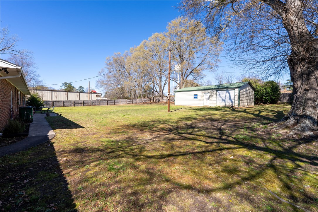300 Green Street Williamston, SC 29697 - Photo 29 of 47 Expansive green space with a detached outbuilding, perfect for diverse outdoor activities.