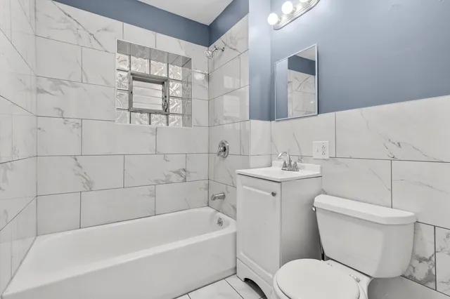 a bathroom with a toilet a sink and bathtub