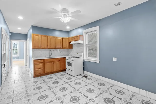 a kitchen with a refrigerator sink and cabinets
