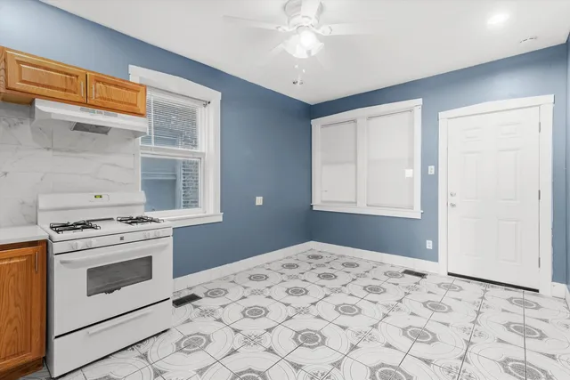 a bedroom with a stove and a window