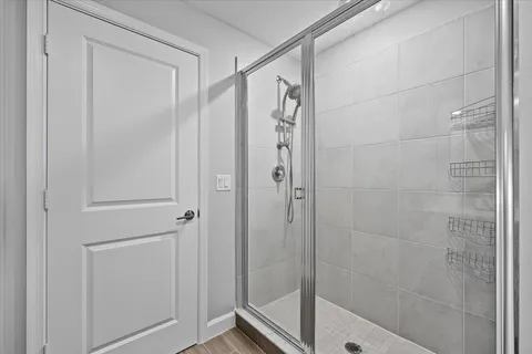a bathroom with a glass door shower