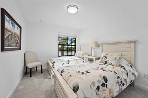 a bed sitting in a bedroom next to a window