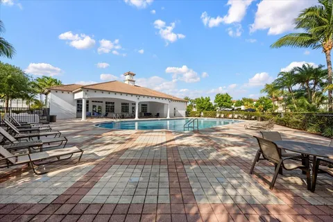 a view of a house with backyard and sitting area