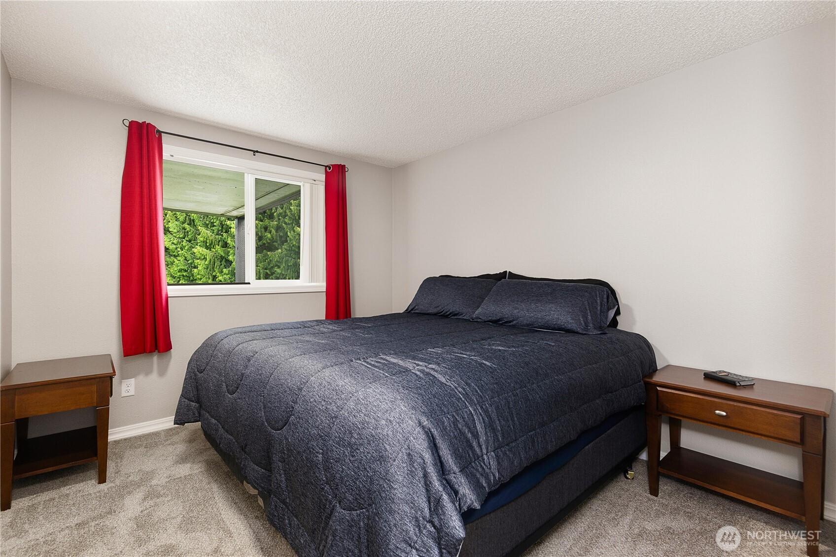 13007 East Gibson Road, Unit U238 Everett, WA 98204 - Photo 22 of 29 a bed sitting in a bedroom next to a window