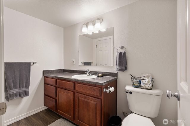 a bathroom with a toilet sink and mirror