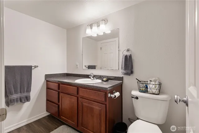 a bathroom with a toilet sink and mirror