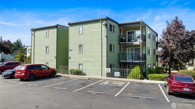 a red car parked in front of a house