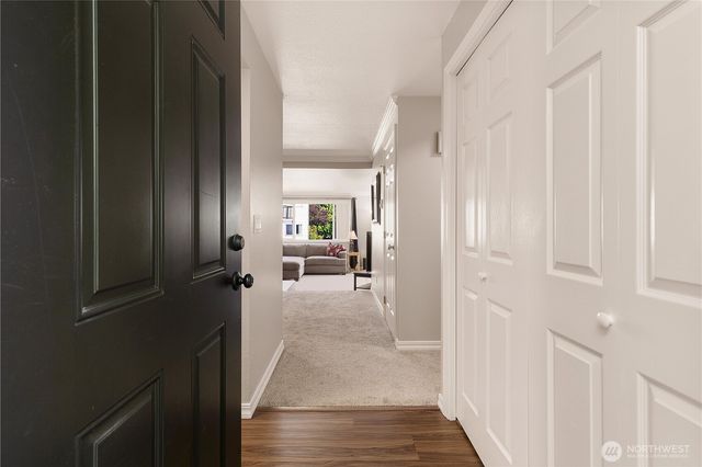 a view of a hallway with a livingroom and furniture