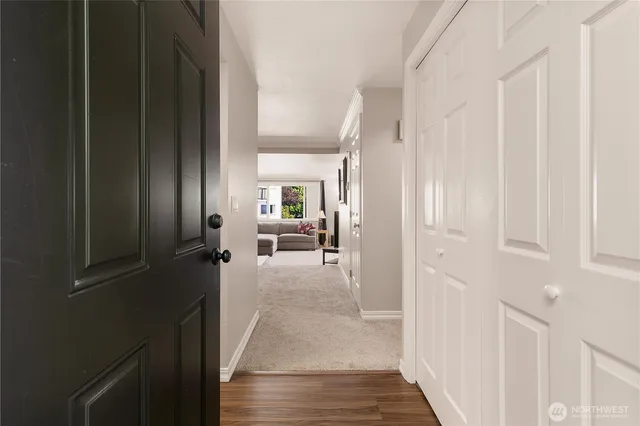 a view of a hallway with a livingroom and furniture