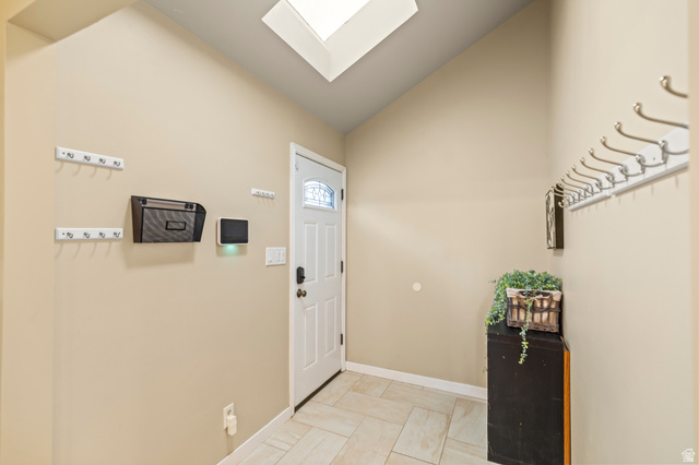 460 Omni Point Road Central Valley, UT 84754 - Photo 30 of 101 Entry foyer featuring solid steel door with decorative glass inlay, overhead skylight, and angled ceiling