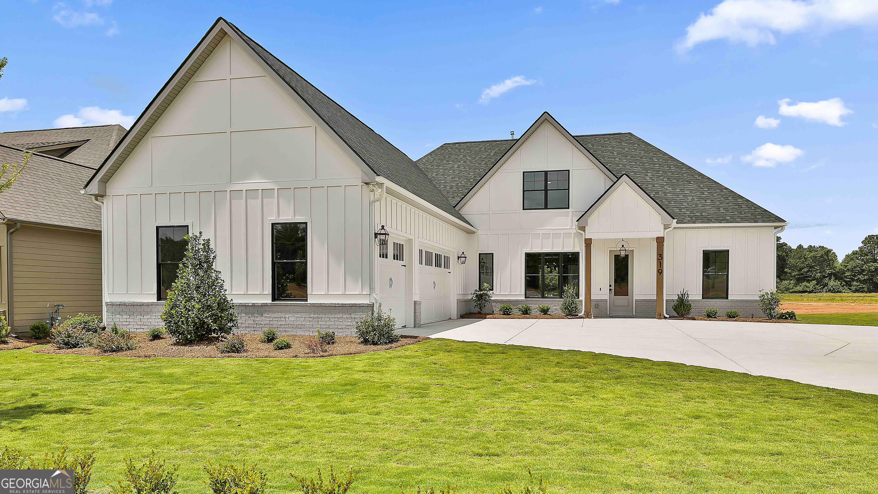 a front view of house with yard and green space