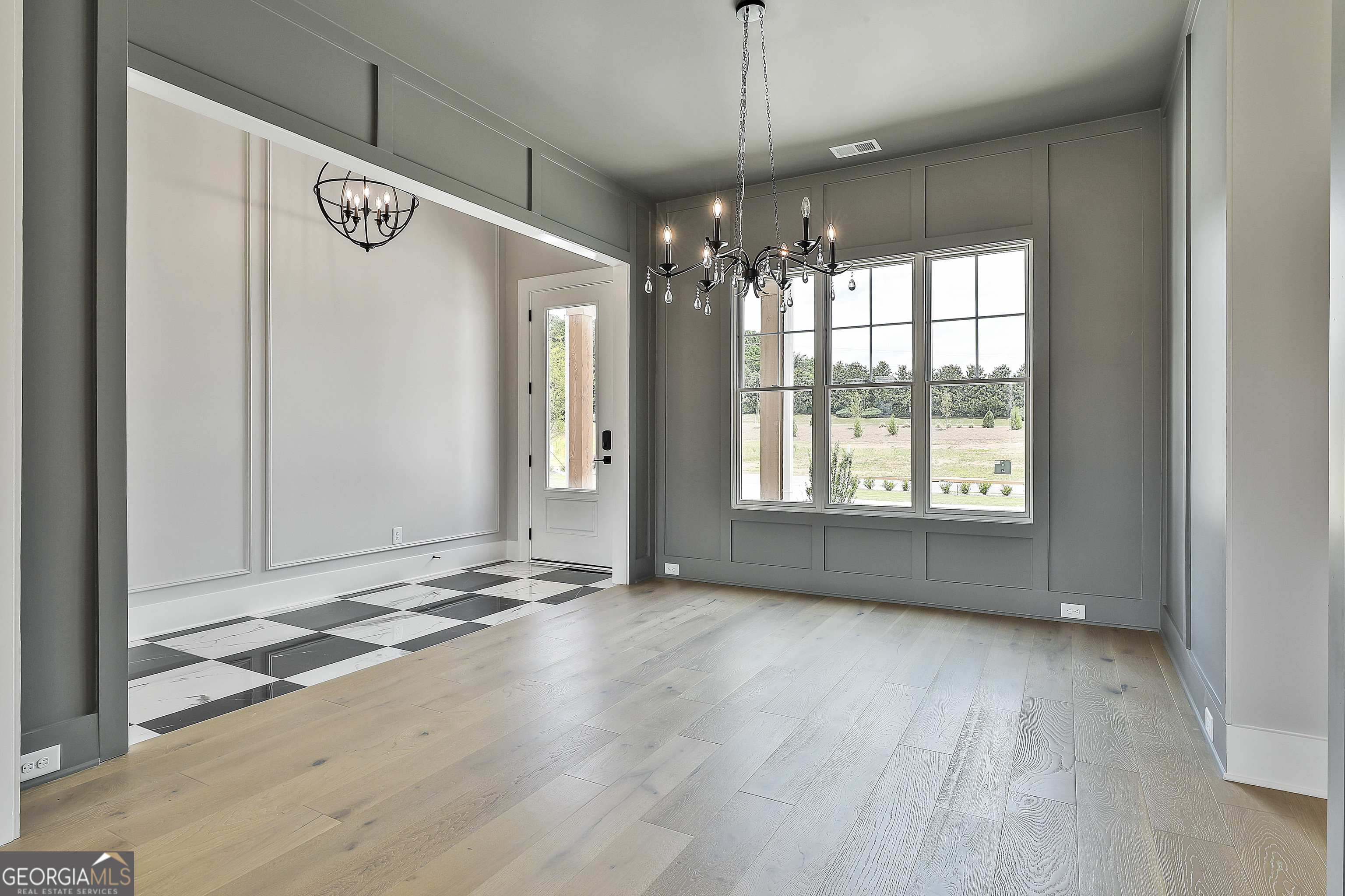 319 Ruffian Circle, Unit 71 Peachtree City, GA 30269 - Photo 11 of 43 an empty room with wooden floor and windows