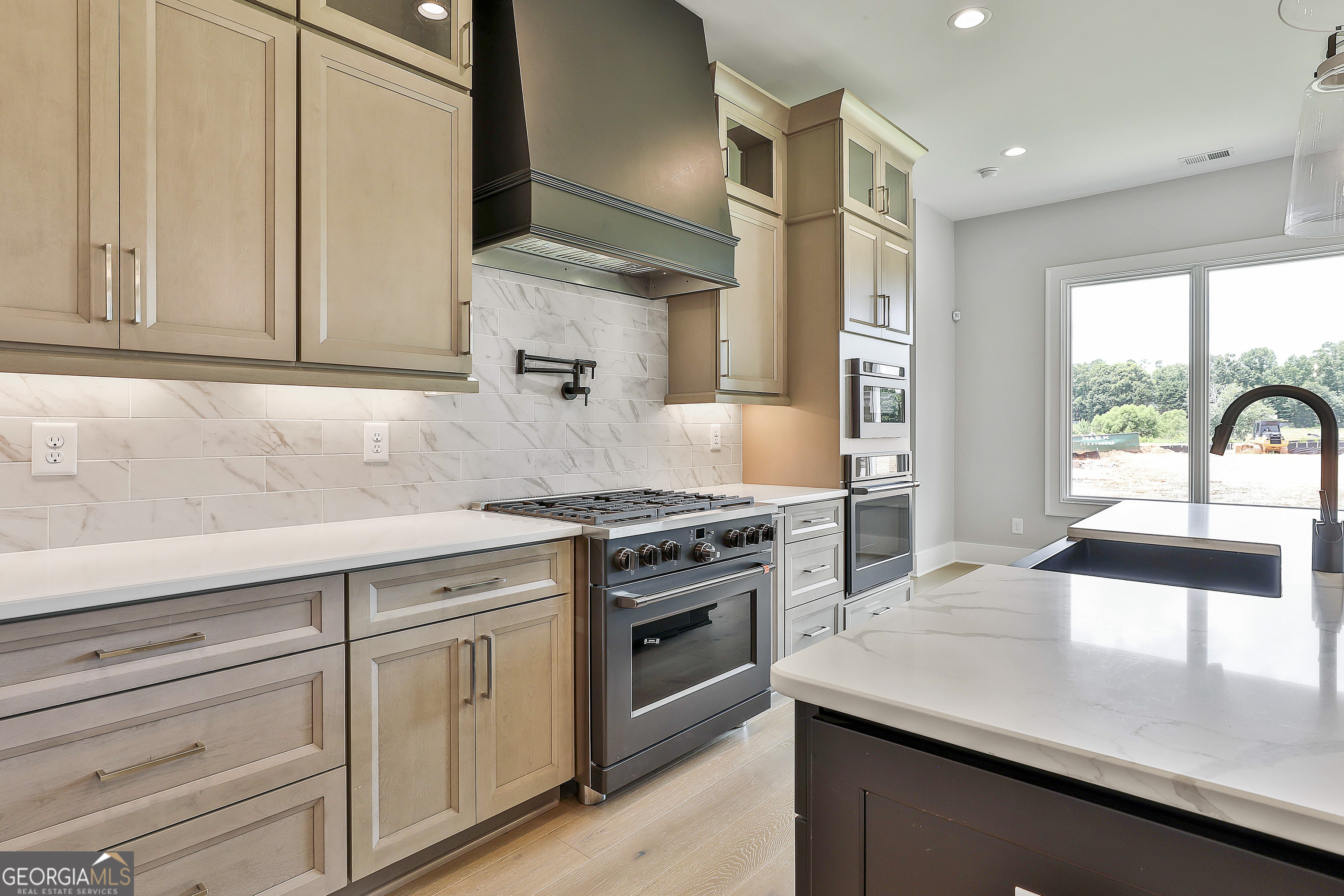319 Ruffian Circle, Unit 71 Peachtree City, GA 30269 - Photo 20 of 43 a kitchen with a sink stove top oven and cabinets