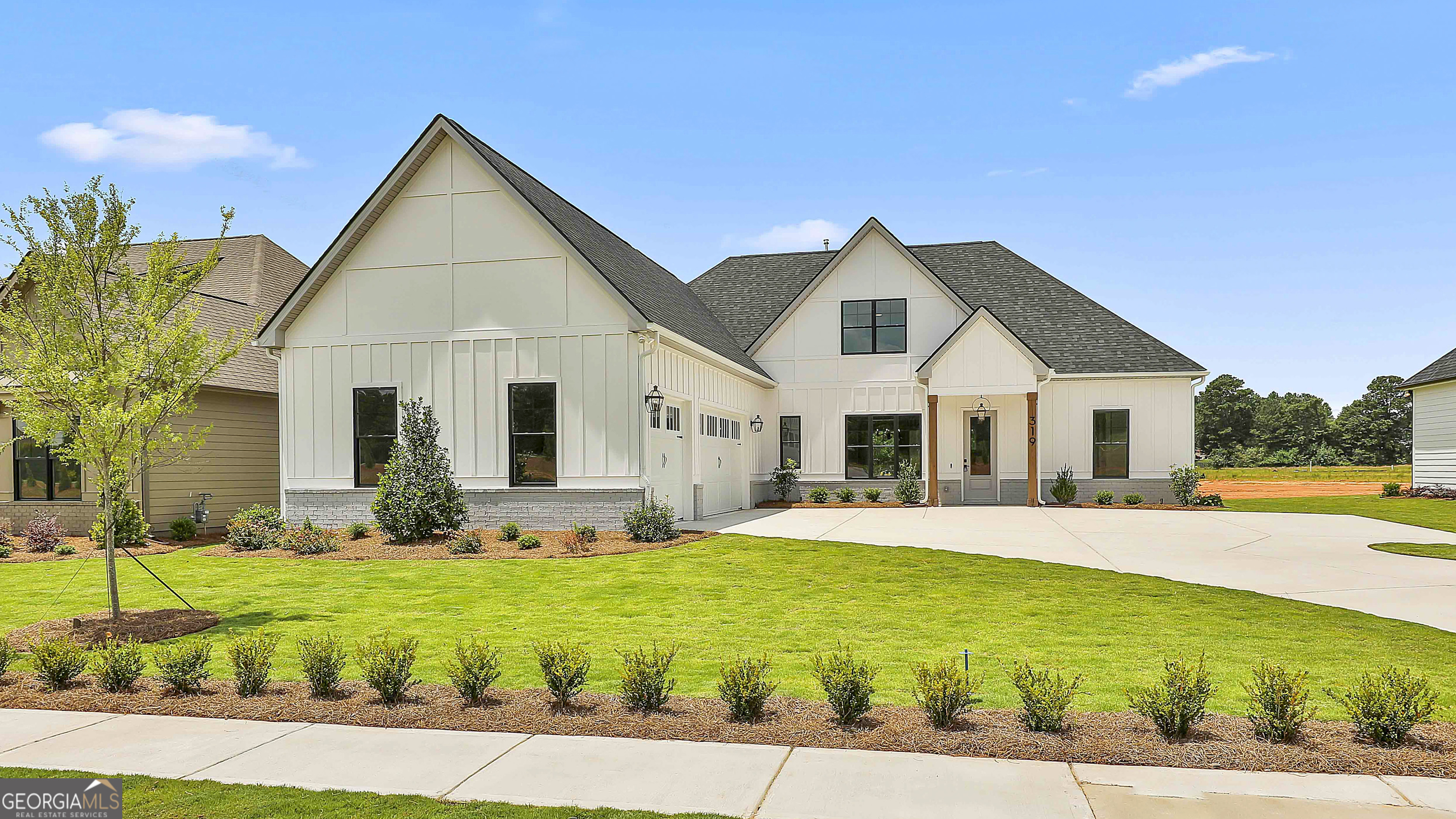 319 Ruffian Circle, Unit 71 Peachtree City, GA 30269 - Photo 2 of 43 a front view of a house with a yard