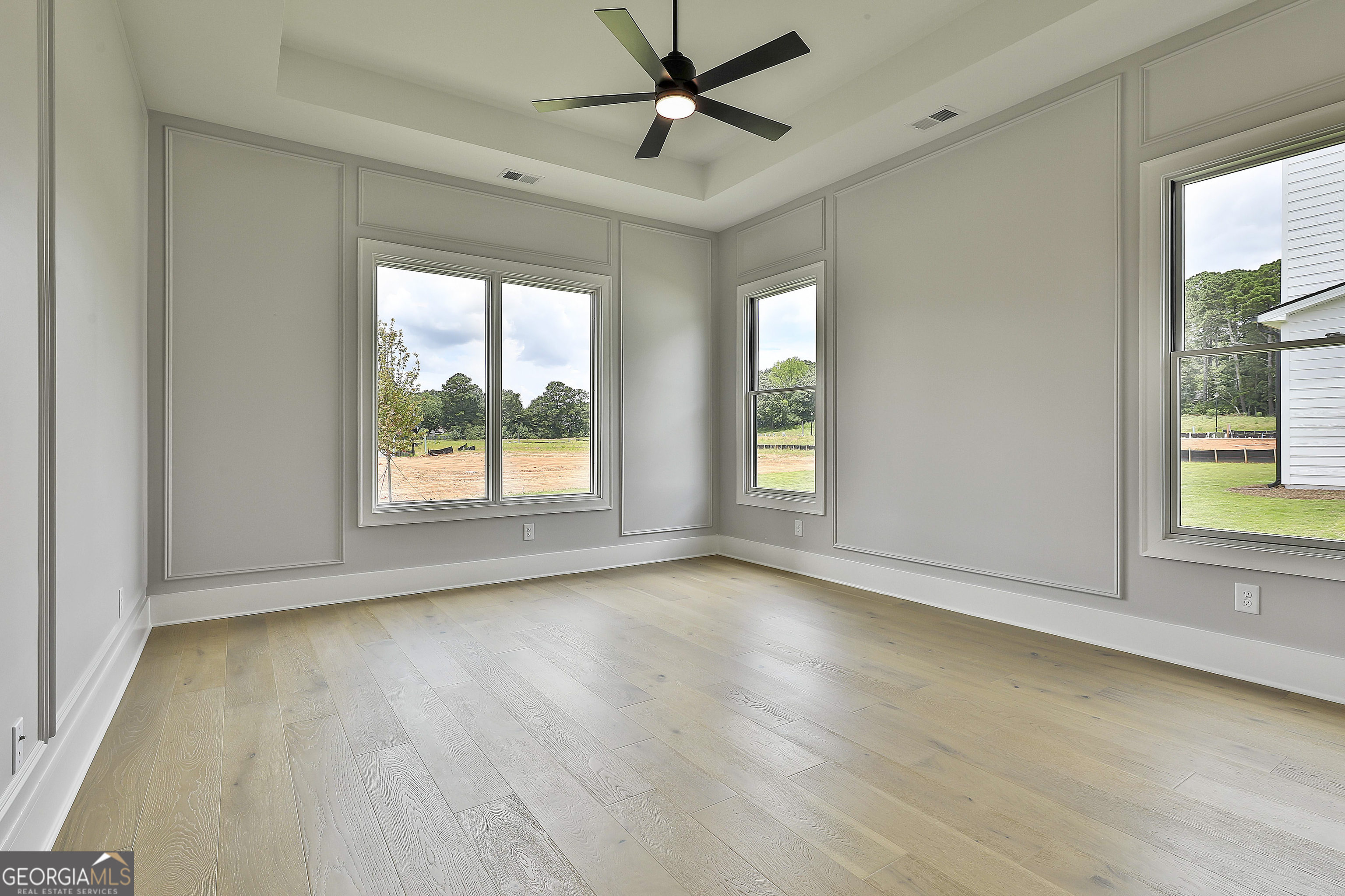 319 Ruffian Circle, Unit 71 Peachtree City, GA 30269 - Photo 24 of 43 a view of an empty room with a window and wooden floor