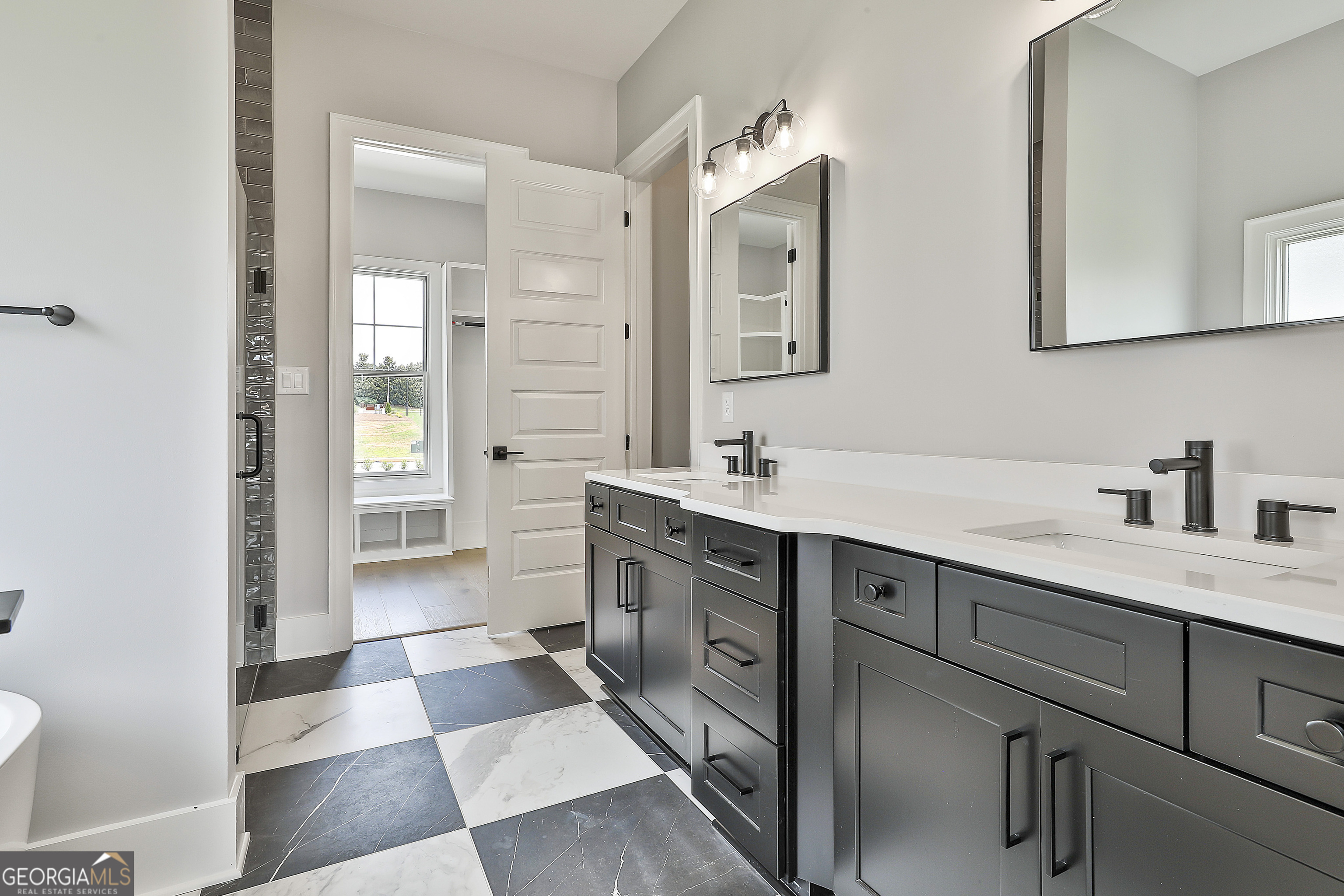 319 Ruffian Circle, Unit 71 Peachtree City, GA 30269 - Photo 25 of 43 a spacious bathroom with a shower a sink and a mirror