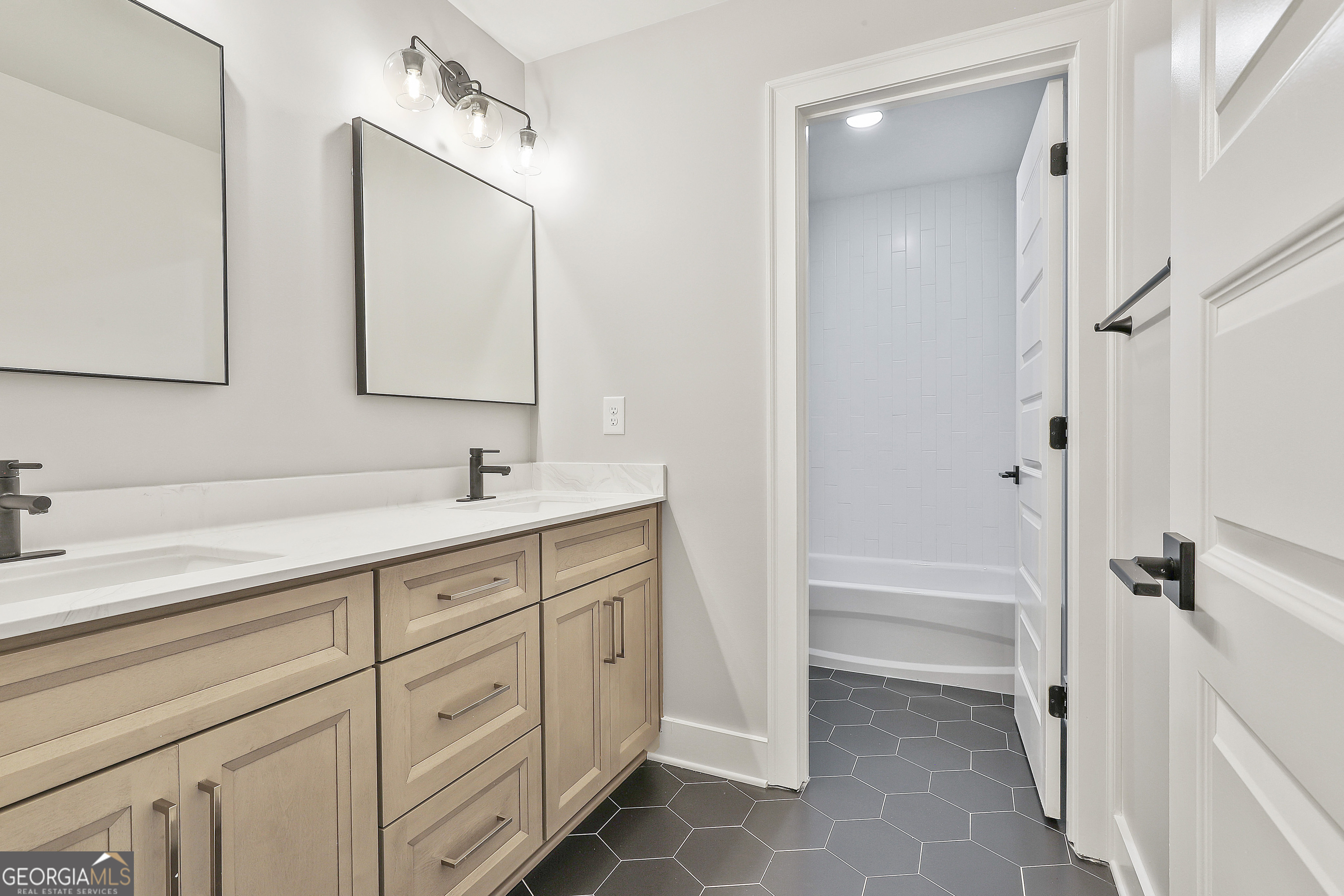 319 Ruffian Circle, Unit 71 Peachtree City, GA 30269 - Photo 37 of 43 a spacious bathroom with a double vanity sink a mirror and a bathtub