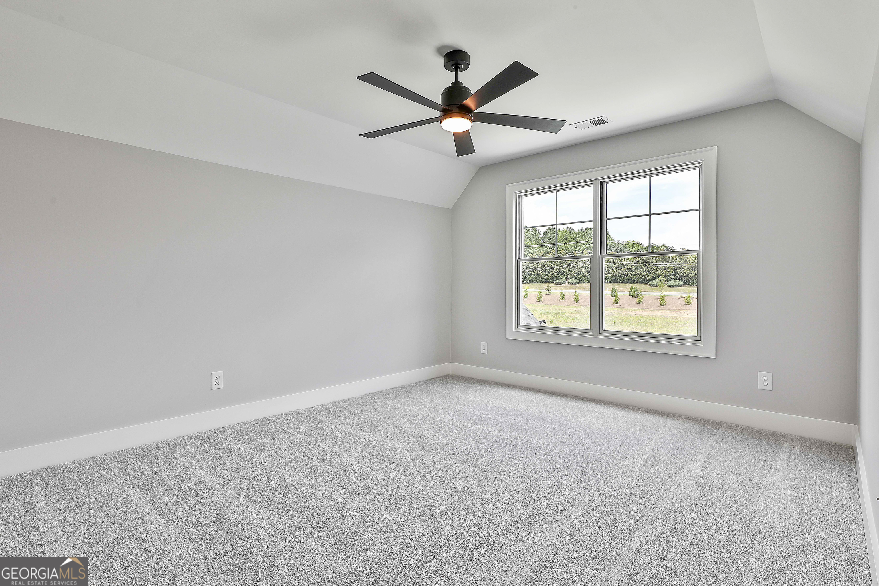 319 Ruffian Circle, Unit 71 Peachtree City, GA 30269 - Photo 38 of 43 an empty room with ceiling fan and windows