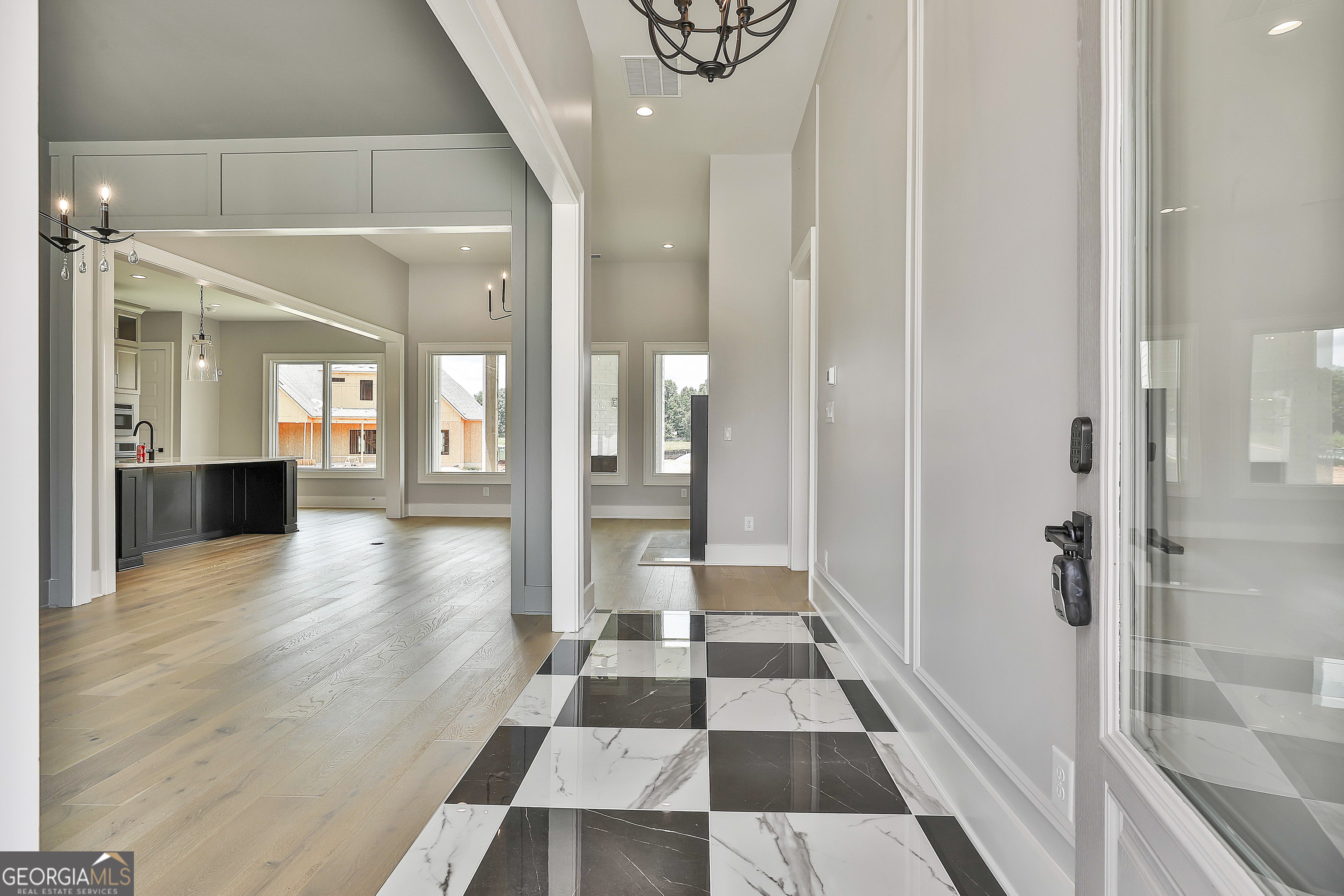 319 Ruffian Circle, Unit 71 Peachtree City, GA 30269 - Photo 6 of 43 a view of a hallway with wooden floor and a bathroom