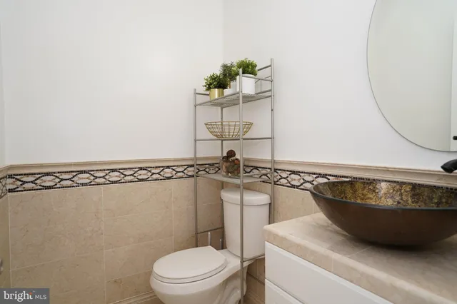 a bathroom with a toilet a sink and mirror