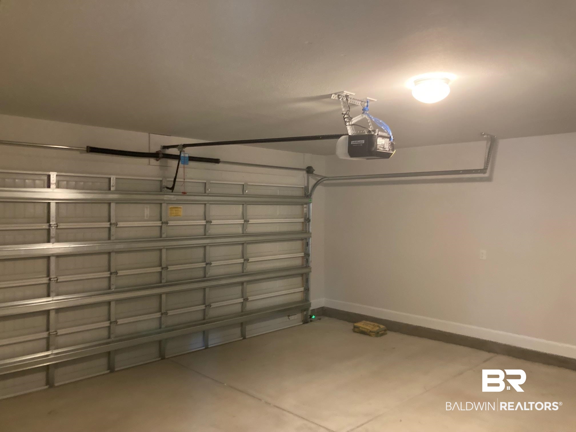 649 Revere Street Foley, AL 36535 - Photo 17 of 18 Garage featuring a garage door opener and baseboards
