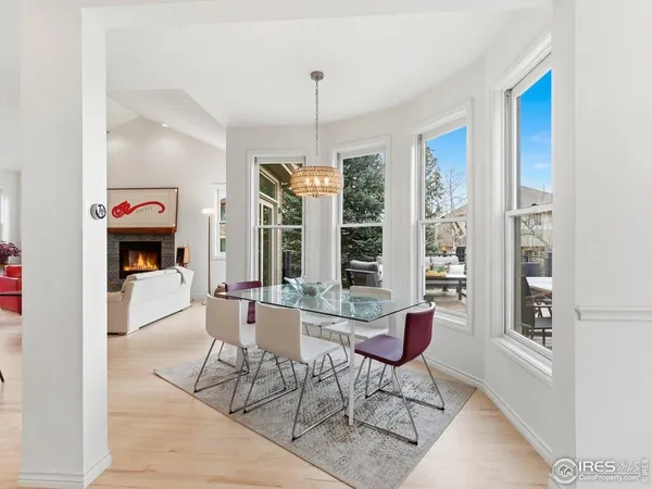 a dining room with furniture a chandelier and window