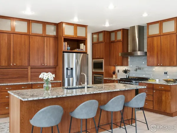 a dining room with furniture a chandelier and wooden floor