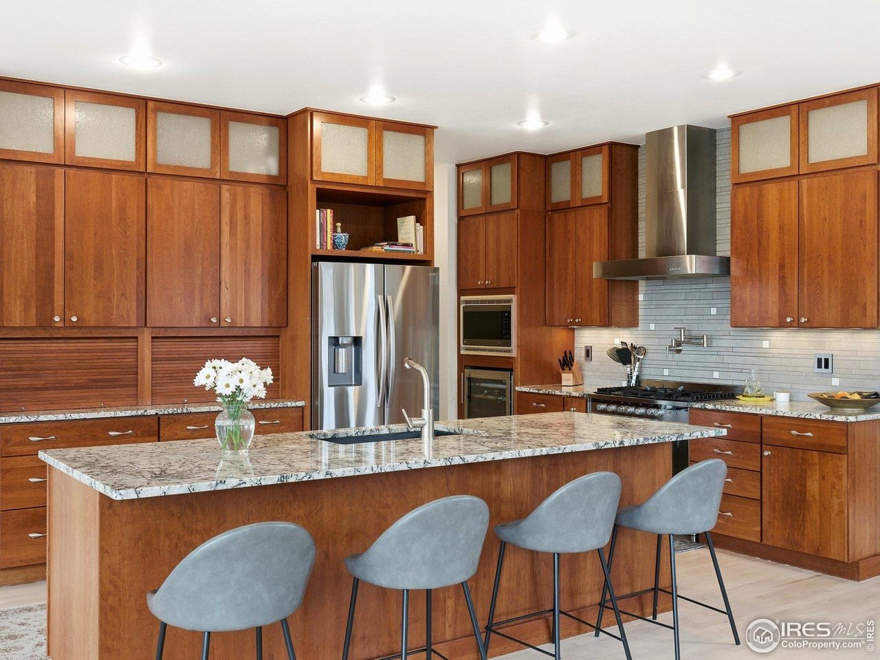 4796 6th Street Boulder, CO 80304 - Photo 17 of 47 a kitchen with stainless steel appliances granite countertop a table chairs in it and wooden floors