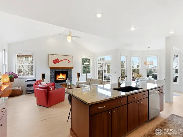 a kitchen with granite countertop a sink stove and refrigerator
