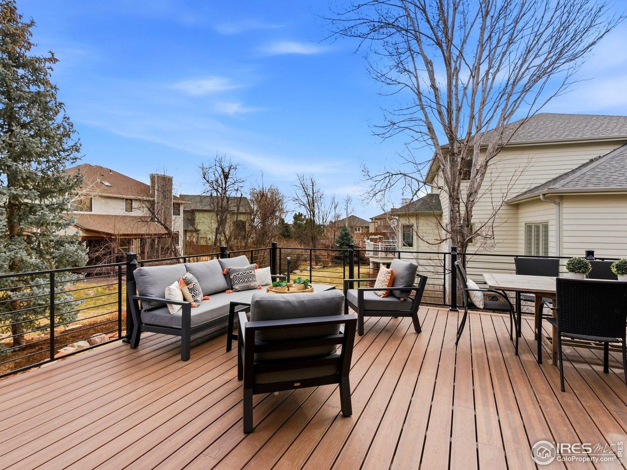 4796 6th Street Boulder, CO 80304 - Photo 41 of 47 a view of a roof deck with table and chairs couches and wooden floor