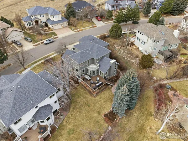 an aerial view of residential houses with outdoor space and parking