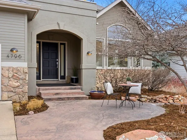a front view of a house with outdoor seating