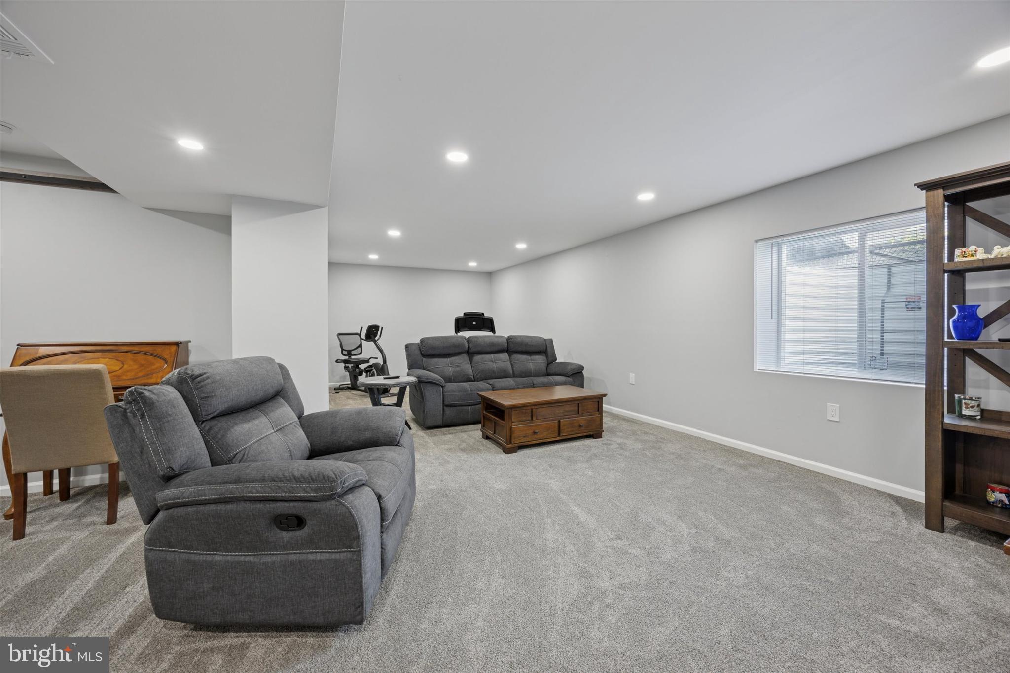 7 Senators Way Berlin, NJ 08009 - Photo 18 of 25 a living room with furniture a window and a flat screen tv
