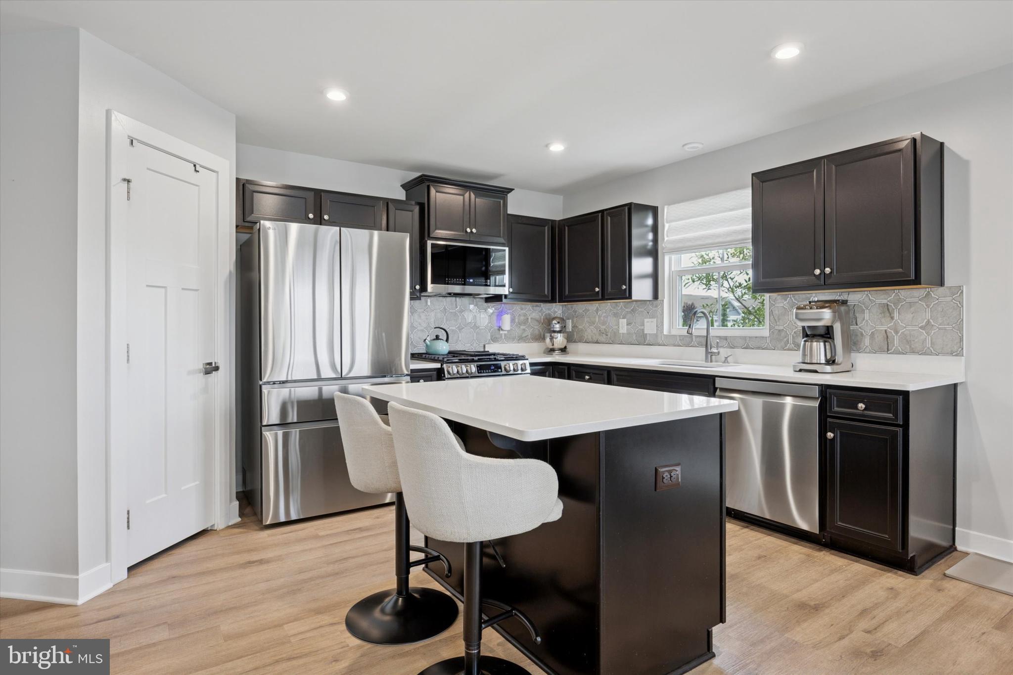 7 Senators Way Berlin, NJ 08009 - Photo 7 of 25 a kitchen with stainless steel appliances granite countertop a sink a stove a refrigerator and a refrigerator