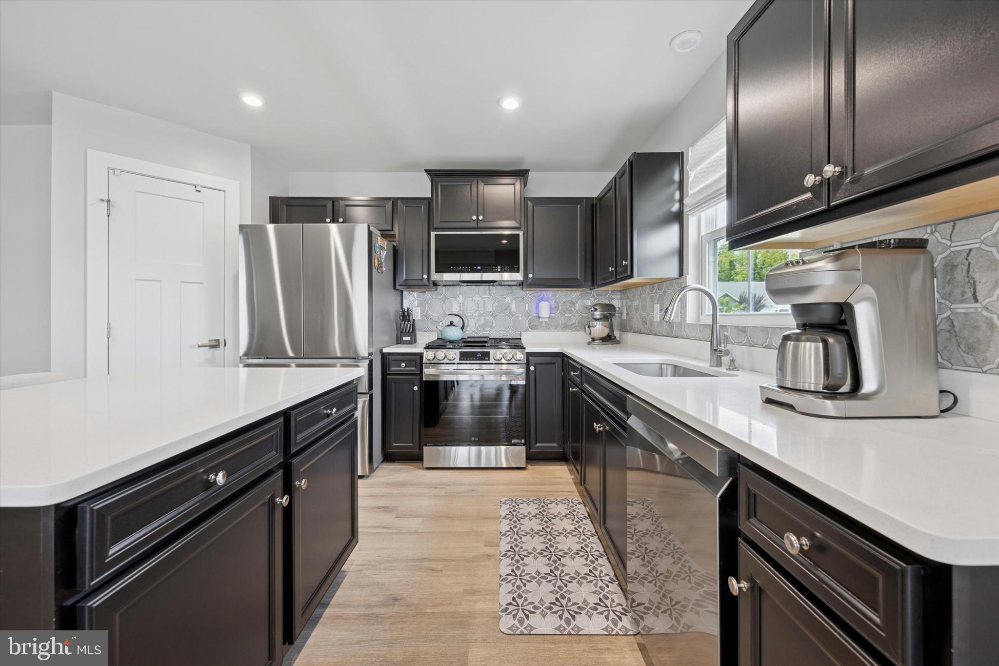 7 Senators Way Berlin, NJ 08009 - Photo 8 of 25 a kitchen with stainless steel appliances granite countertop a sink a stove and a refrigerator