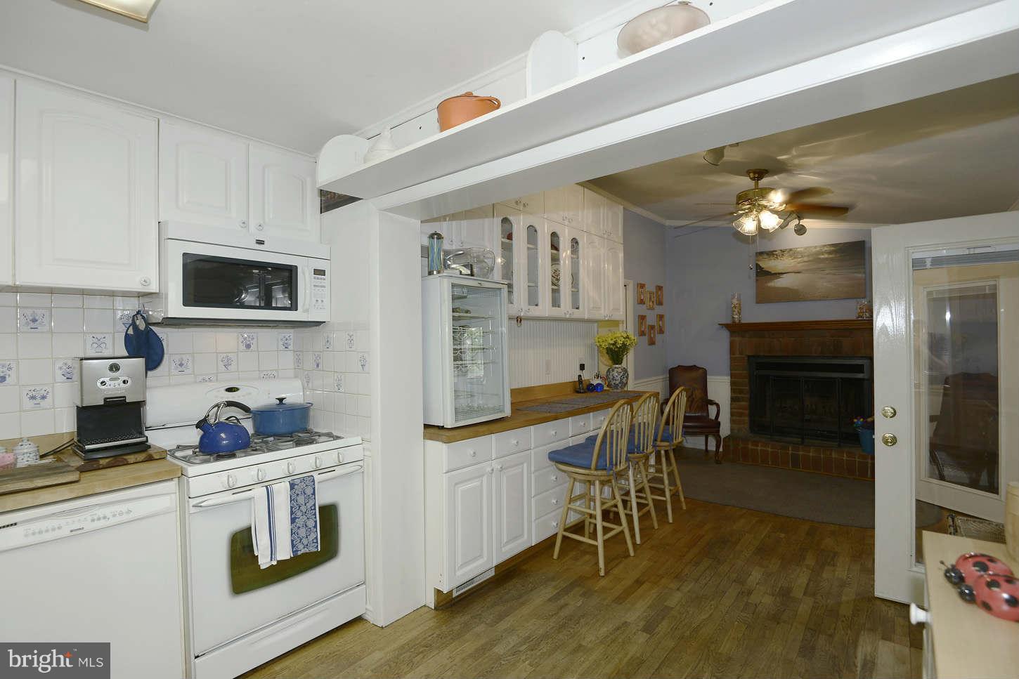 12110 Selfridge Road Silver Spring, MD 20906 - Photo 12 of 26 a kitchen with a sink stove and white cabinets