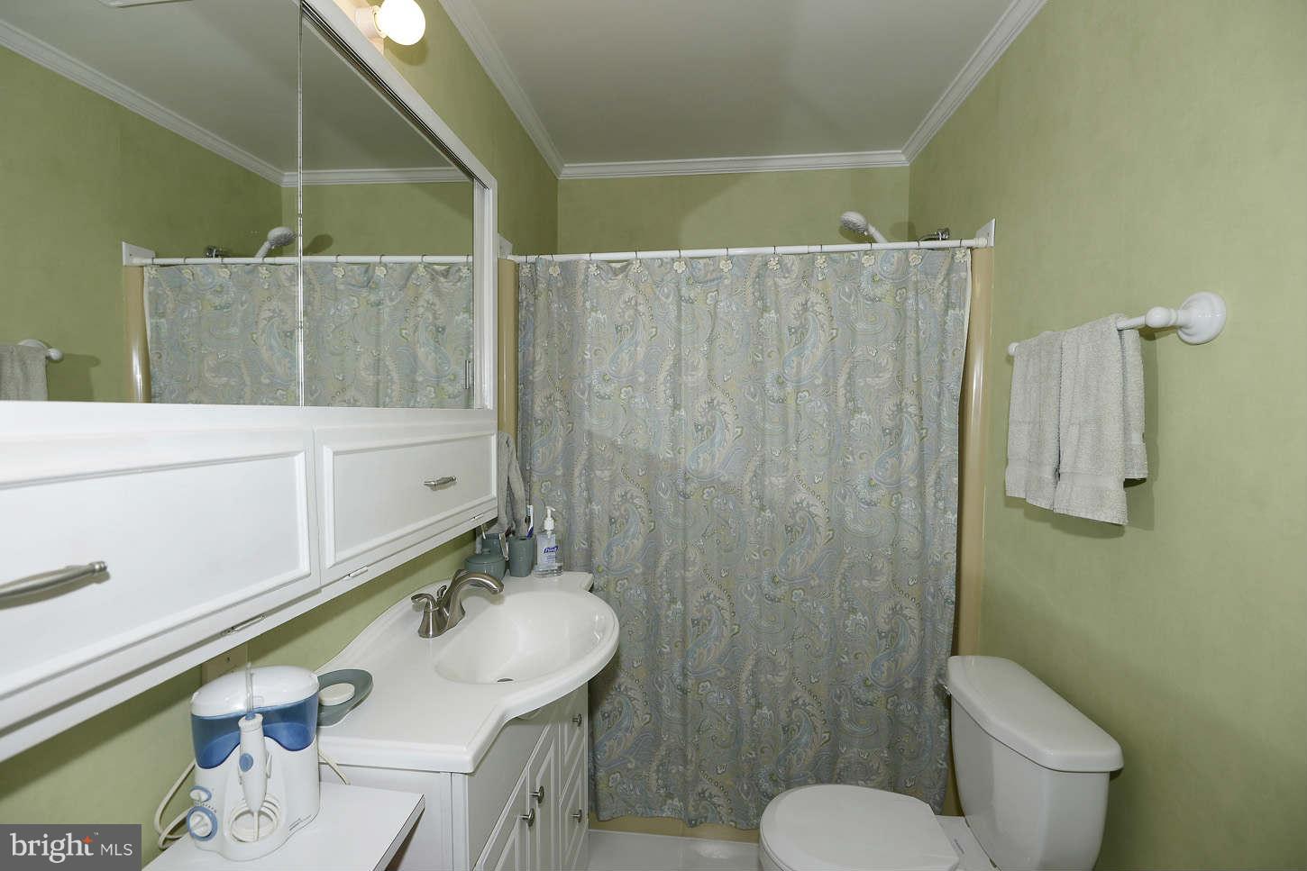 12110 Selfridge Road Silver Spring, MD 20906 - Photo 15 of 26 a bathroom with a sink a toilet and shower