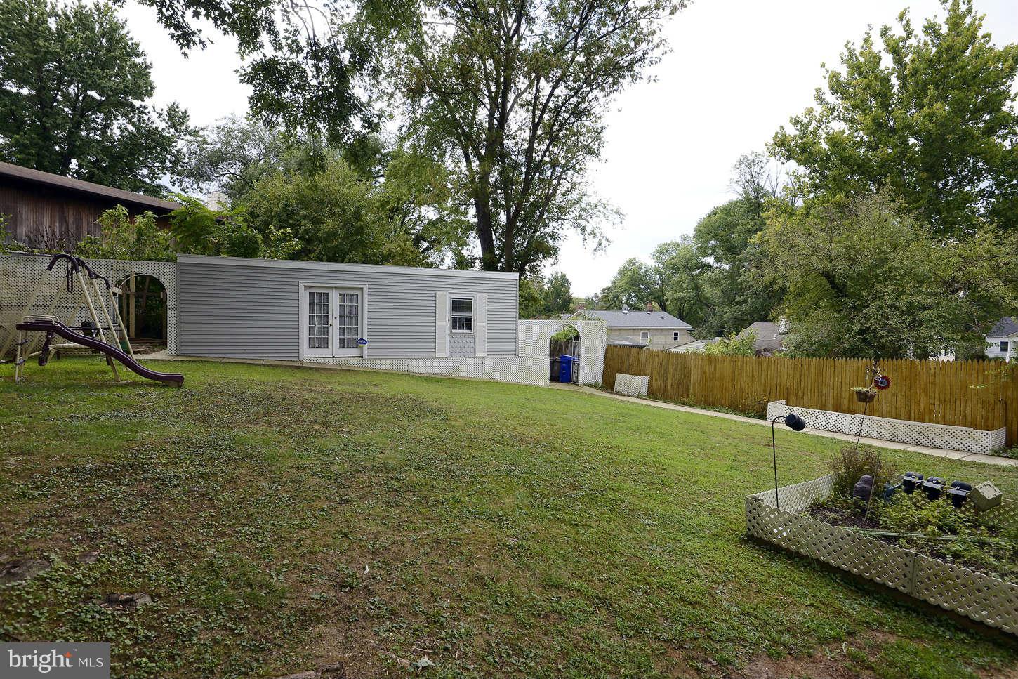 12110 Selfridge Road Silver Spring, MD 20906 - Photo 20 of 26 a backyard of a house with lots of green space