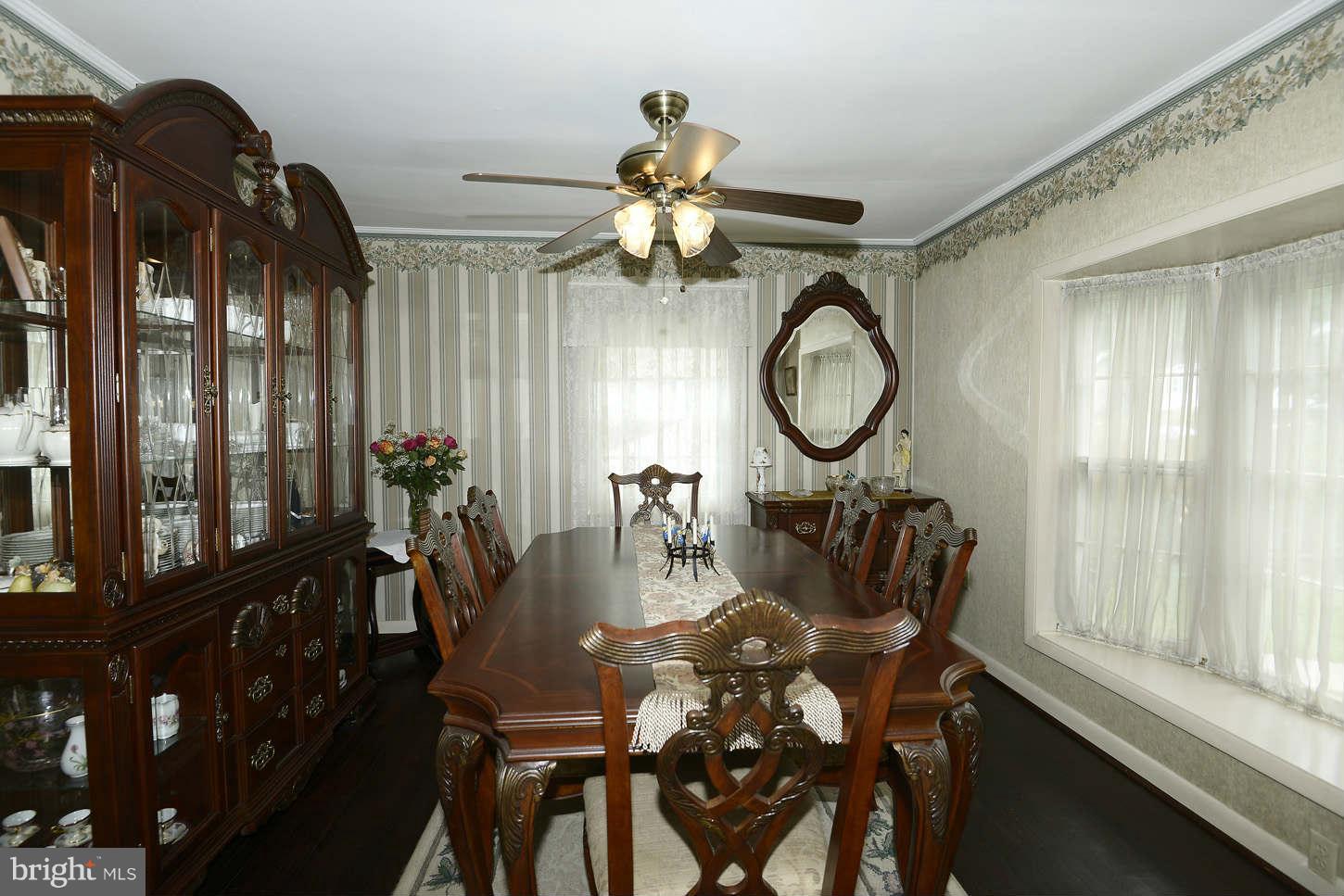 12110 Selfridge Road Silver Spring, MD 20906 - Photo 6 of 26 a dining room with furniture a chandelier and wooden floor