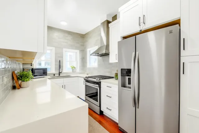 a kitchen with stainless steel appliances a refrigerator sink and stove