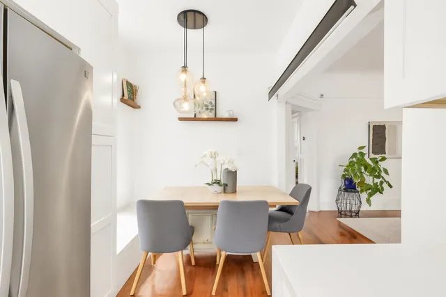 a view of a dining room with furniture and a chandelier