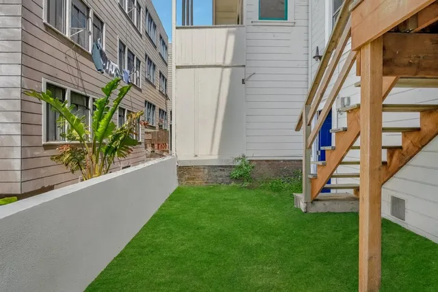 a view of a pathway of a house with a yard