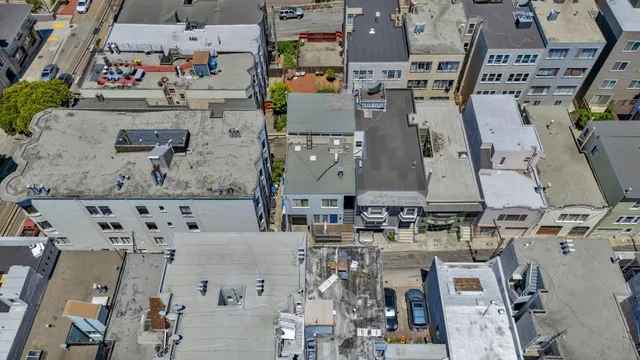 an aerial view of residential houses with outdoor space
