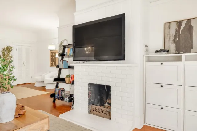 a living room with furniture a fireplace and a flat screen tv