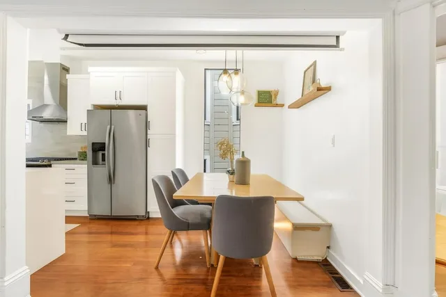 a view of kitchen with furniture and refrigerator
